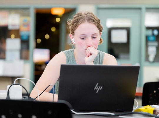 student working at her computer